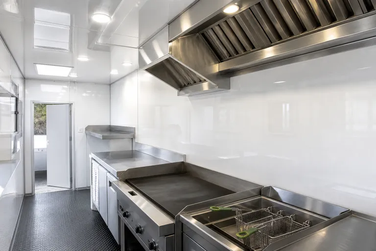 Food truck cooking bay with stainless steel range and gelcoat wall panels